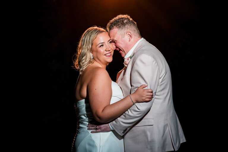 Happy couple embracing on wedding day.