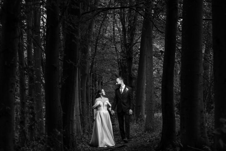 Bride and groom walking in dark forest