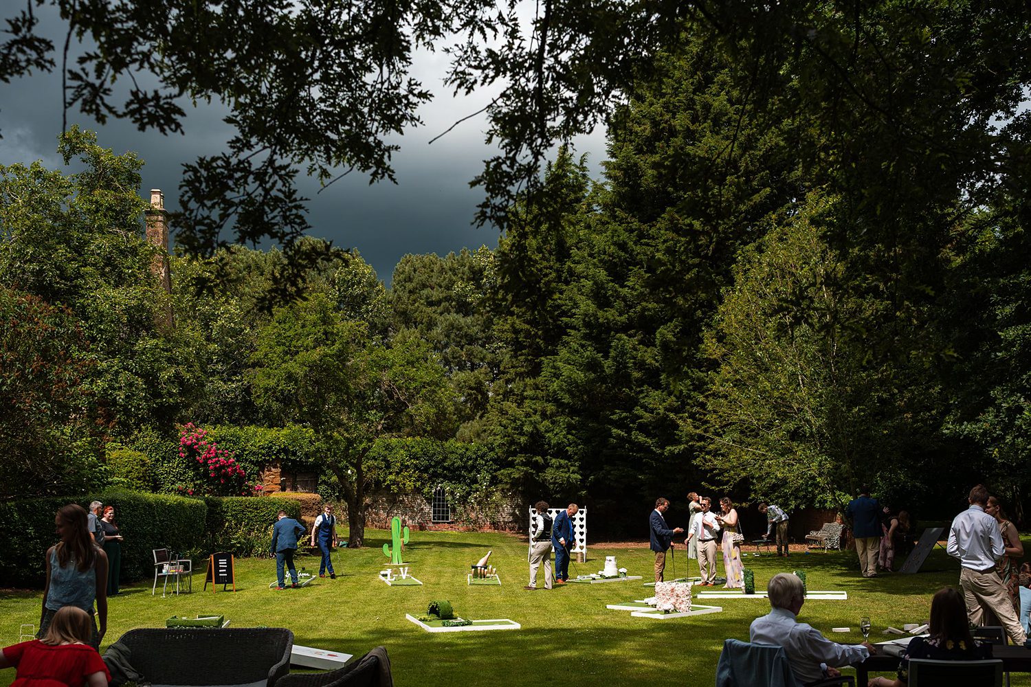 Guests playing lawn games at garden party
